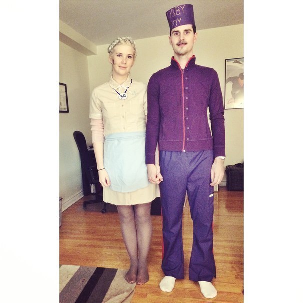 One person in a maid outfit and one person in a purple bellhop suit