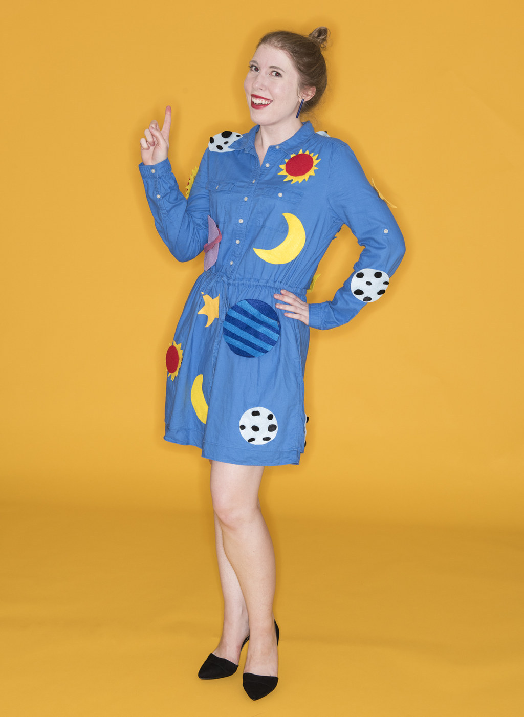 Woman in a minidress with sun, moon, and star patches