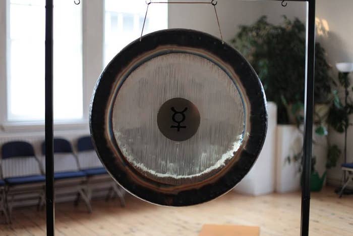 It's a Friday and the exodus to the pub is happening. You on the other hand are making your way to a Gong Bath. Yes. An actual Gong Bath. On a Friday.So what exactly is a Gong Bath? I'll be honest, I wasn't entirely sure either. Turns out there are no baths, but a candle lit room with a selection of instruments, multiple Gongs, himalayan singing bowls, bells, wind chimes, and rainsticks. We haven't even started yet and I feel relaxed. You are immediately put at ease, swapping the usual wine for a lemon and ginger and undoing rituals of make up and hair for gym gear and water. You are (almost) put to bed. You lie on mats, there's a pillow for your head and feet, lavender filled eye masks, and a blanket to cover you. And then all is quiet. I can't even hear the London sirens. It's strange for a Friday, but I like it. The Gong Bath was created by an American man, Don Conreaux in the 1960's and it's said that listening to a Gong and its effects is like having a 'sound massage' because of the strong waves the Gong produces.So for the next hour orchestrated sounds from an array of worldly instruments are played - and played beautifully. At one point there's a Gong that produces waves of air that sift over the room. There's instruments that sound like thunder, rain and the sea as the sound rolls across the room. The clever bit is how the sound moves, often distant, then close and distant again. When the hour finishes I genuinely feel like I've awoken from a deep sleep, although I never slept once. My back and neck feel like I've had a deep massage, yet no one came close...it's apparent the sound waves are doing something right. As far as doing the class on a Friday night, I couldn't think of anything better, you start the weekend as you mean to go on, it's refreshing to be sober at 9.30pm and the idea of a hangover-free Saturday is something I could get used to. To get involved and book a place check out: http://www.meetup.com/London-Gong-Baths-Sound-Massages/http://www.meetup.com/Brighton-Sound-Massages/