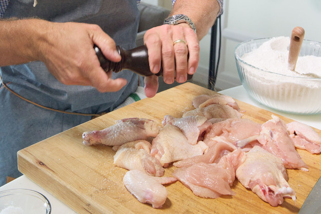 Set the chicken pieces on a cutting board and season liberally with salt and pepper on all sides.