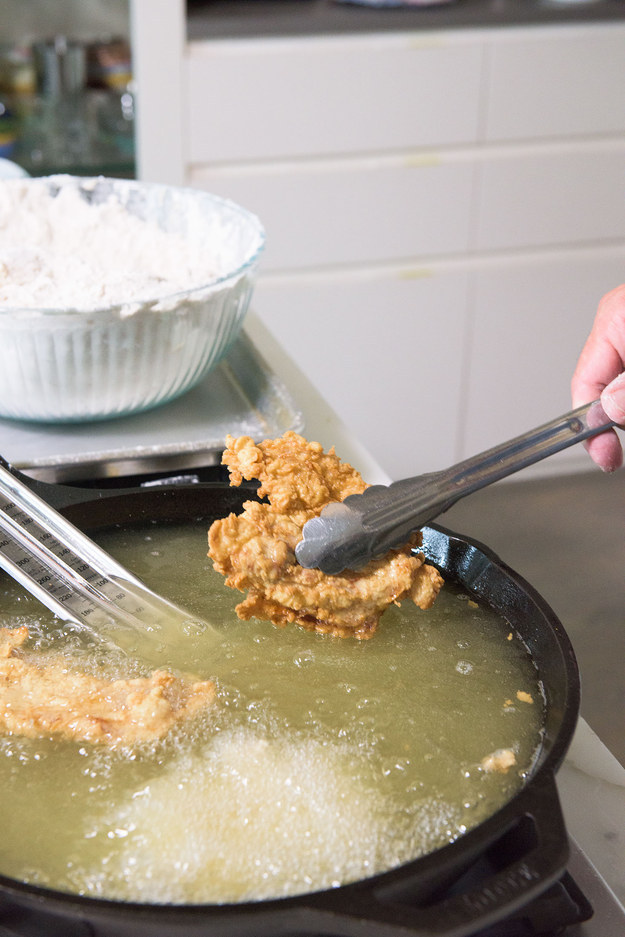 Use tongs or a slotted spoon to carefully flip each piece of chicken.