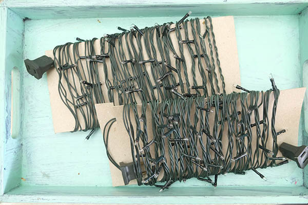 Solution: Use pieces of cardboard to neatly wrap up your lights for next year. See how it's done, and get more tips for holiday decoration clean up at Make It Blissful.