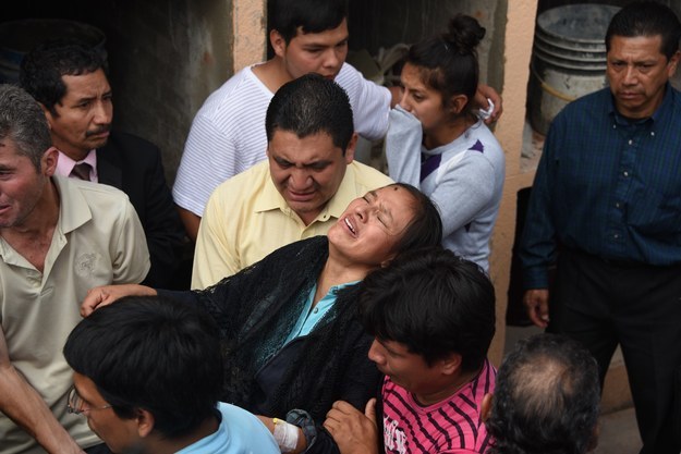 Una mujer llora durante el funeral de su esposo que fue encontrado entre los escombros.