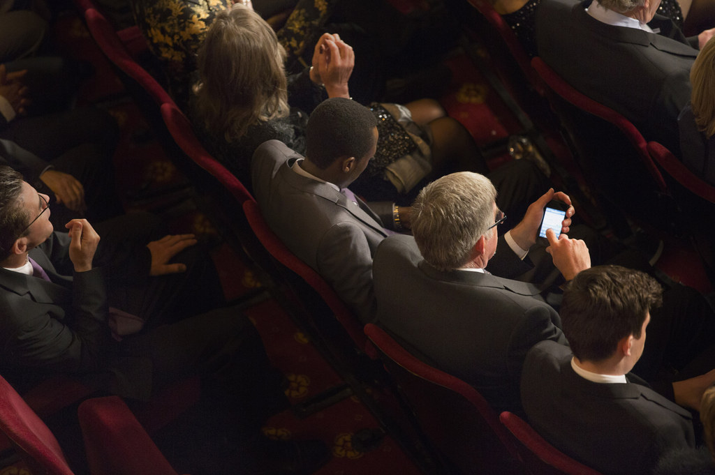 We're guessing you paid good money to watch the show, not your phone!