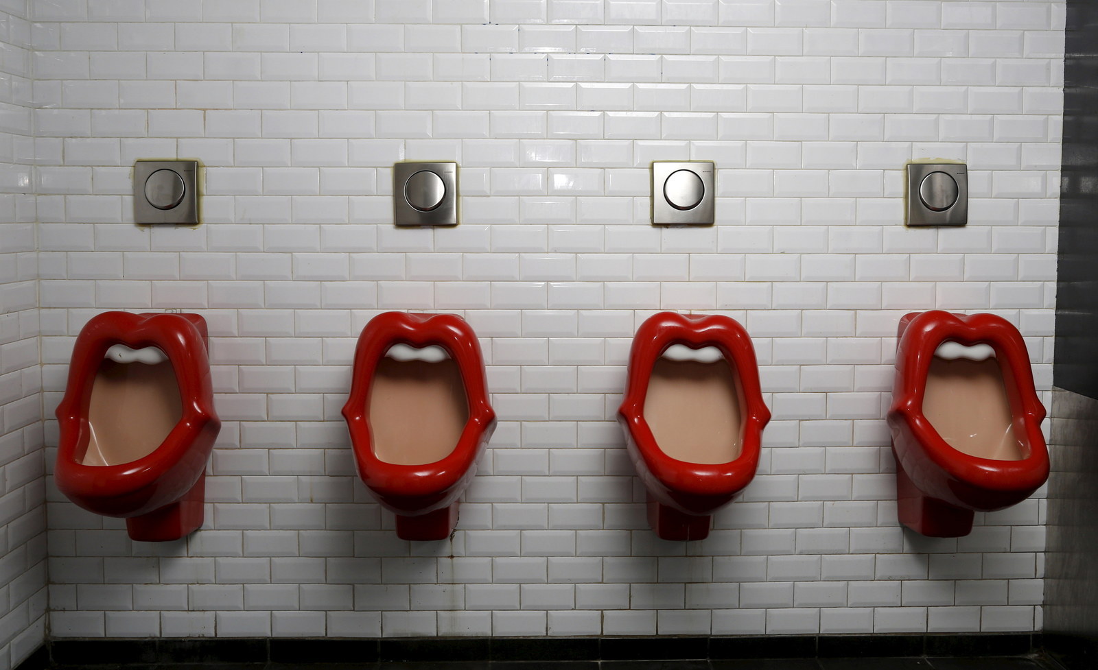 Urinals inspired by the Rolling Stones lips and tongue logo are seen in a b...