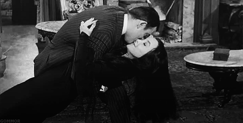 Gomez is not embarrassed to be caught adoring Morticia like the goddess she is. Often, he doesn't even stop in company until Morticia politely unwinds herself.