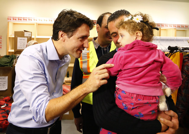 The PM was on hand to greet the 163 new arrivals at Toronto Pearson International Airport himself, taking time to bond with adorable children...