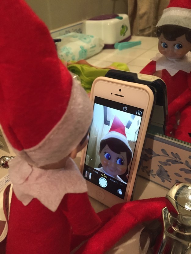 An elf looking at their image in a cellphone