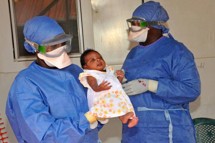 Medical workers present Noubia, the last known patient to contract Ebola in Guinea, during her release in November.