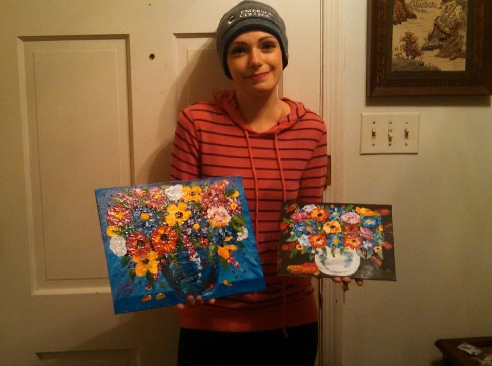 Sarah with two of her paintings.