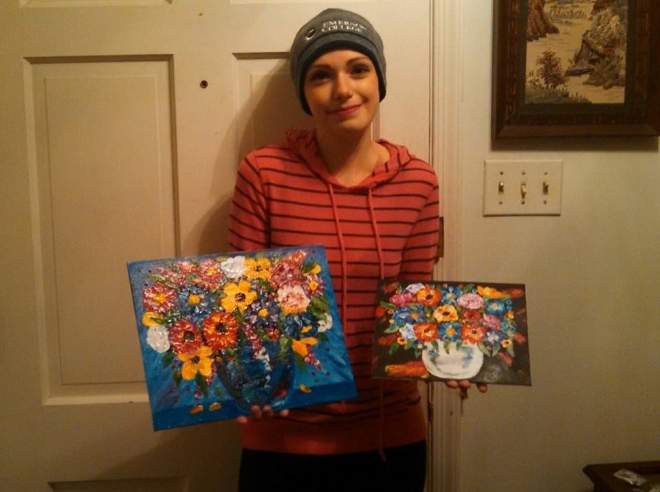 Sarah with two of her paintings.