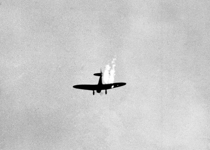 A Japanese plane goes into its last dive as it heads toward the ground in flames after being hit by Naval anti-aircraft fire.