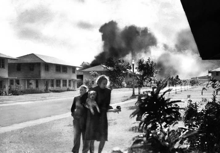 Officers' wives head to their quarters after hearing explosions and seeing smoke in distance. Mary Naiden, the woman who took this picture, is said to have exclaimed, "There are red circles on those planes overhead. They are Japanese!"