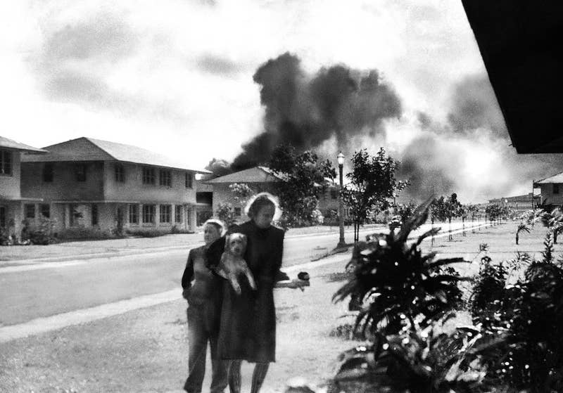 Officers&#x27; wives head to their quarters after hearing explosions and seeing smoke in distance. Mary Naiden, the woman who took this picture, is said to have exclaimed, &quot;There are red circles on those planes overhead. They are Japanese!&quot;