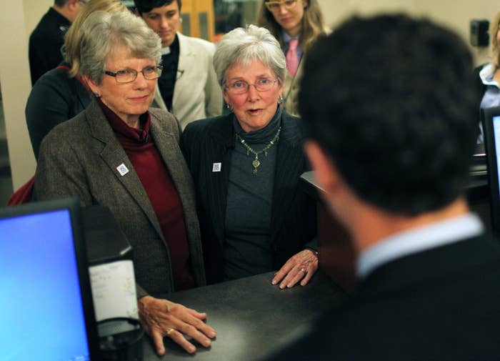 Carol McCrory, left, and Brenda Clark, center, speak to Buncombe County Register of Deeds Drew Reisinger, right, after applying for a marriage license at the Buncombe County Register of Deeds office in Asheville, N.C.