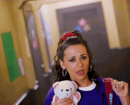 Innocent high-schooler with hoop earrings, a scrunchie, and a teddy bear