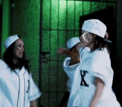 Baseball cap, jersey, and hoop earrings