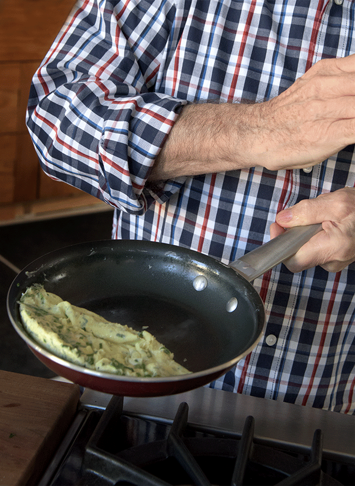 He has done this about a million times in his life, so it's pretty easy for him. For someone who *hasn't* (me?), this is kinda tricky and may take some practice. The good news is that this is optional, and even if you don't master this part, the omelette will still taste 100.