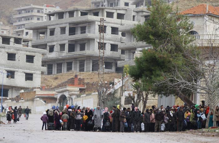Madaya residents wait for a convoy of aid from the Syrian Arab Red Crescent to arrive.
