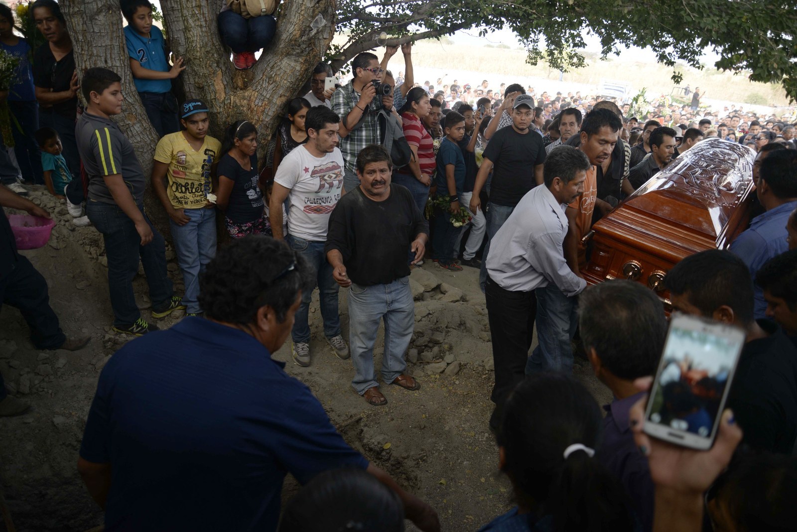 Mourners carry the coffin of the slain mayor of Temixco, Gisela Mota, to the cemetery in Pueblo Viejo, Mexico, Sunday, Jan. 3, 2016.
