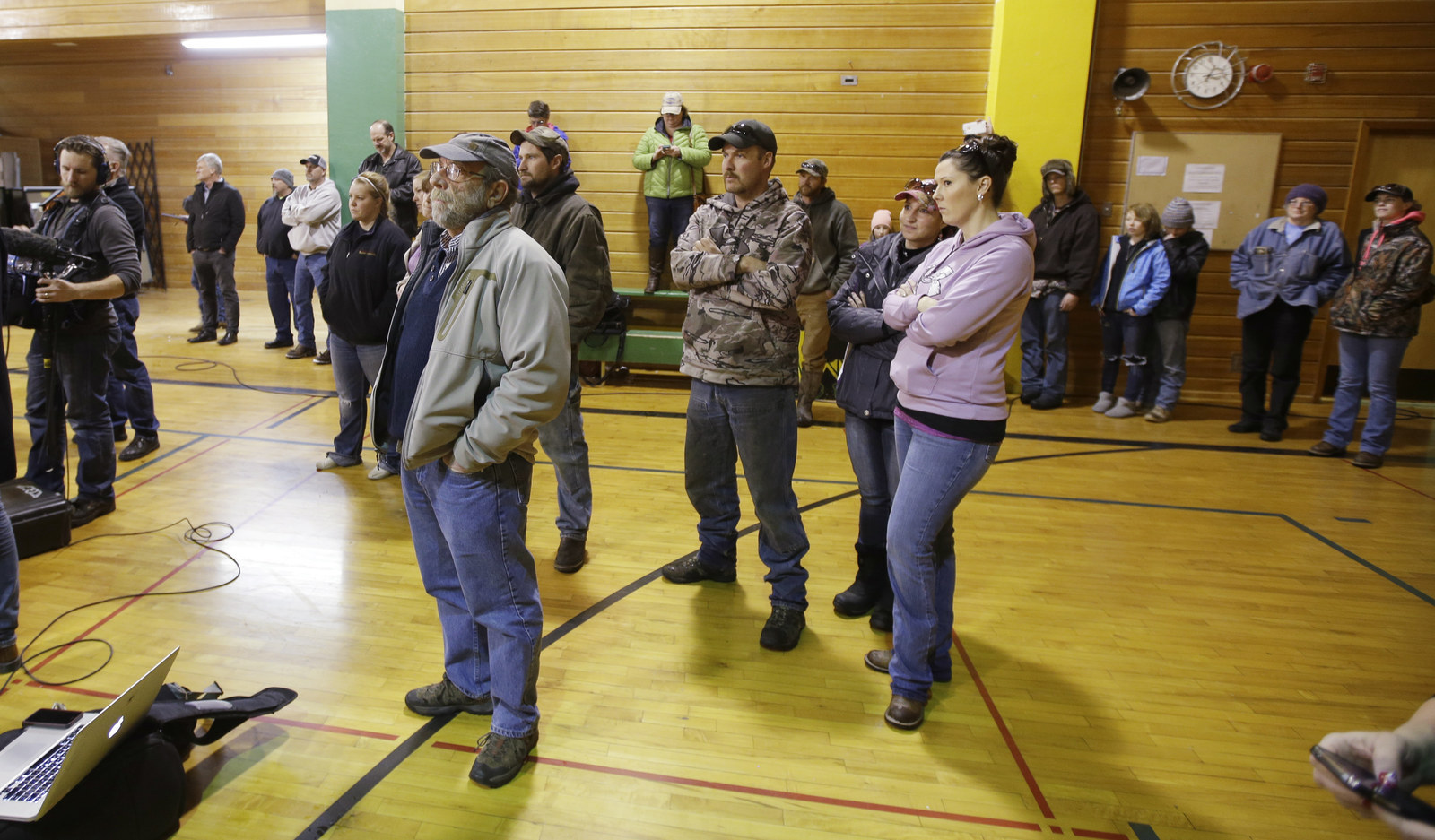 Residents look on as Harney County Sheriff David Ward speaks to the media.