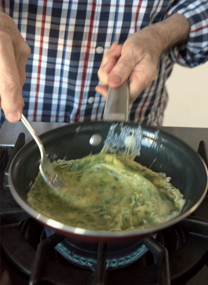 Remember, the eggs will start to cook around the edges first, so it's important to clean the sides of the skillet and bring that cooked egg into the center.