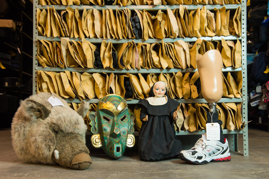 A soft toy boar's head, a carved wooden mask, a nun doll and a prosthetic leg are among the items at the Transport for London lost property office, in central London.