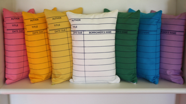 Pillows that resemble library checkout cards.