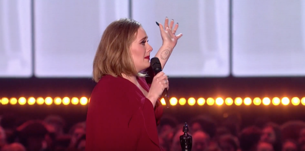 When Adele won her third Brit Award of the night, the Global Success Award, she was pretty emotional on stage and said to the crowd "you're probably fucking bored of me anyway."