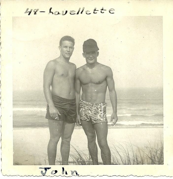 Two shirtless men in an old photograph from years ago