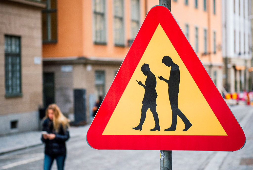A road sign warning against pedestrians focusing on their smartphones is pictured on near the old town in Stockholm, Sweden.