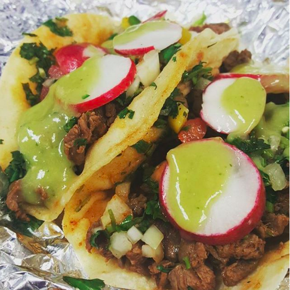 Well, how about some tacos de juicy, tender carne asada, sprinkled with chopped onions and cilantro, and drizzled with some bomb-ass salsa verde?