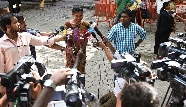 Prithika Yashini smiles outside Madras High Court after a judgment cleared her to be India's first transgender police sub inspector.