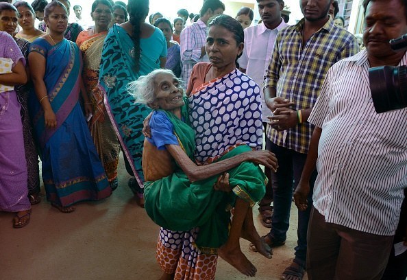 One Chennai resident carries another to a polling station so she can cast her vote.