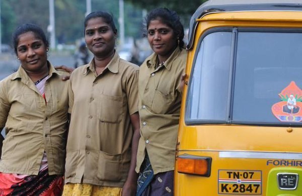 Three women, who support their children and families, pose with their livelihood.