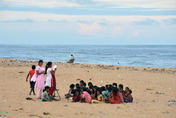 Fishermen's children sit through a Bible reading class on Marina Beach.