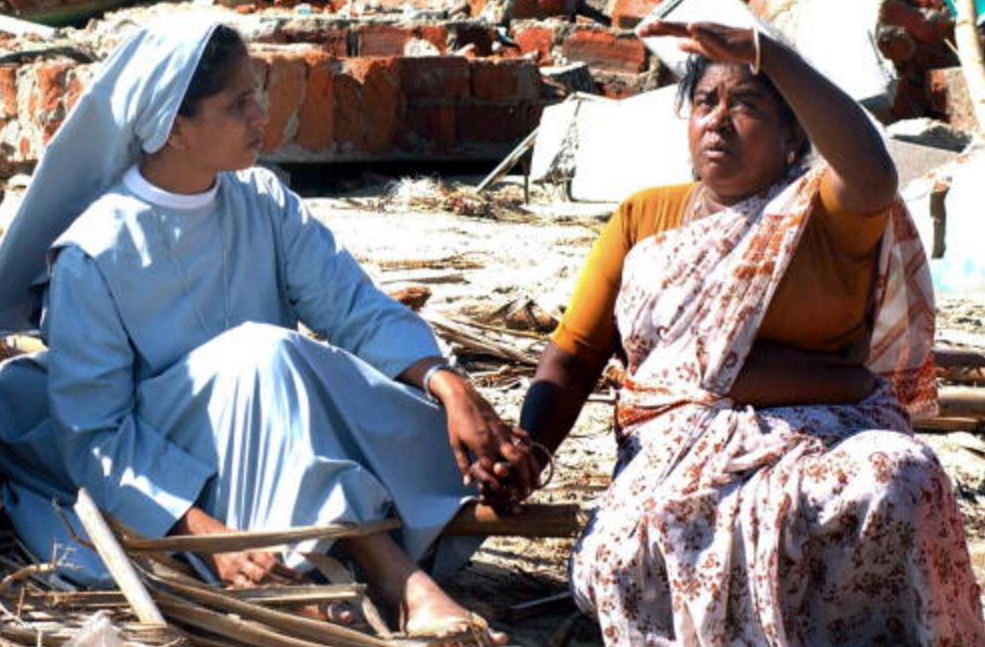 A nun sits with 2004 tsunami survivors in the weeks after the calamity, lending a hand, an ear, and a shoulder.