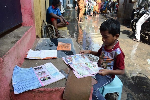 After severe floods, a boy salvages his most valuable possessions – his school books.