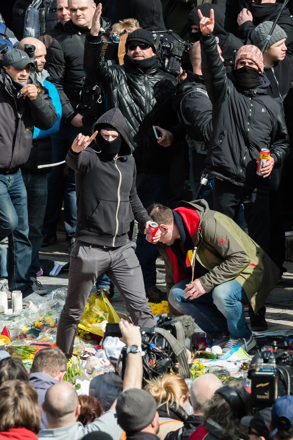 A right wing protestor walks on flowers.