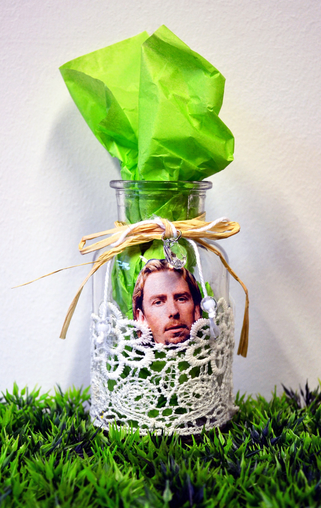 This cottage-inspired vase is made with a piece of lace, raffia, and a jewel accent. And Chad Kroeger.
