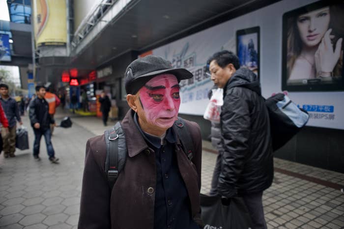 Dairen Huang walks to Zhengjia Mall in Guangzhou, where he will perform Yu Opera with his friends.
