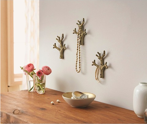 Tree branch wall hooks to hang your jewelry on.