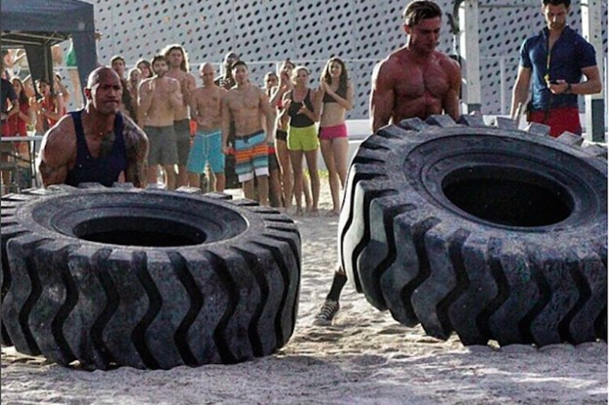 The Rock Unsurprisingly Beat Zac Efron In A Tire-Flipping Race