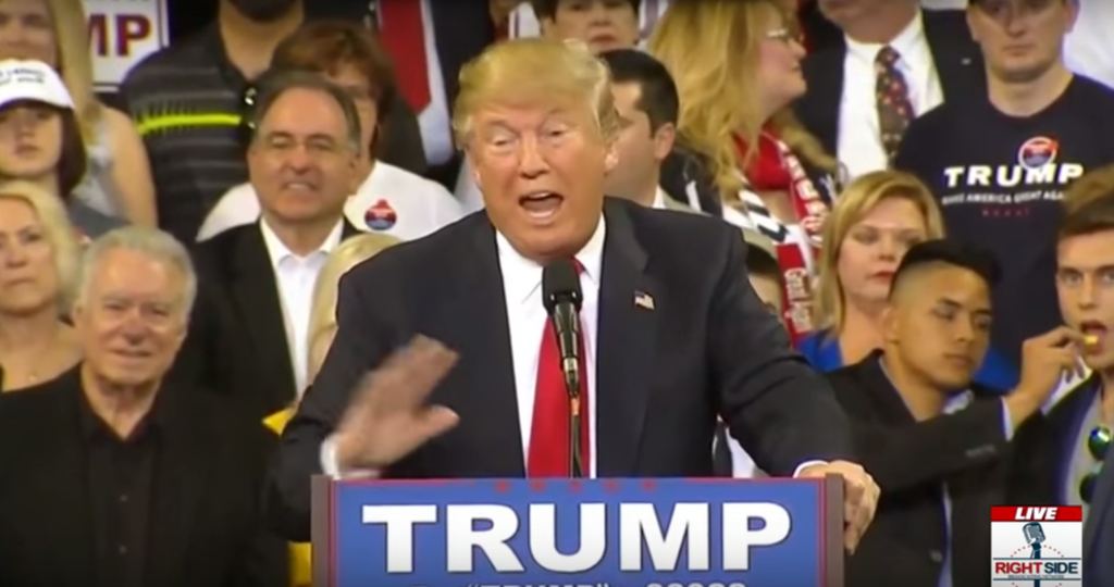 This Guy Feeding Another Guy A Chip Behind Donald Trump Is A Thing Of 