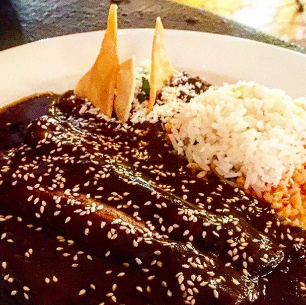 Mole consists of over 20 ingredients, most notably a wide range of chili peppers and chocolate (yeah, chocolate). But unlike your typical Hershey's chocolate syrup, the chocolate hangs back and only helps the mole to achieve a certain smokey flavor.