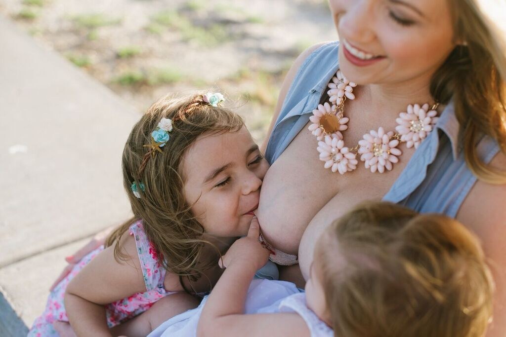 Mother Breast Feeding Teen Daughter