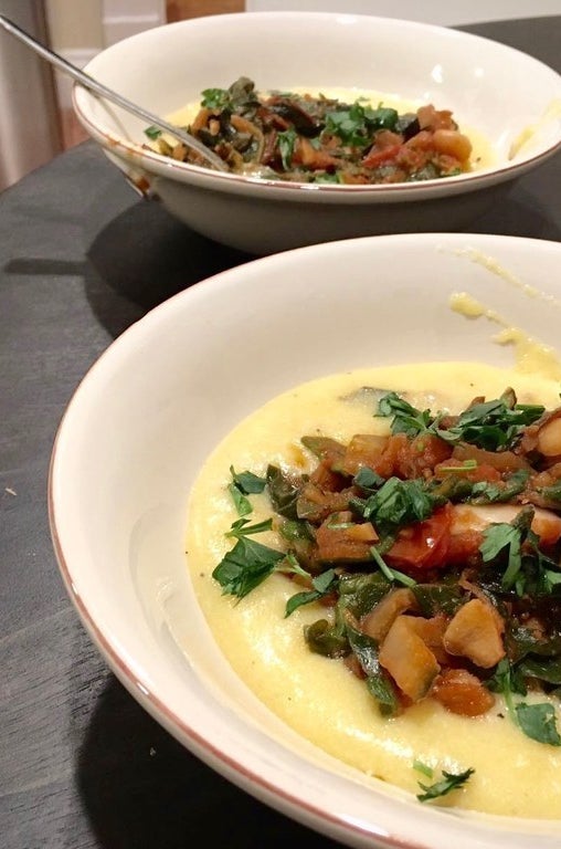 The plated dish: swiss chard and white bean stew over polenta
