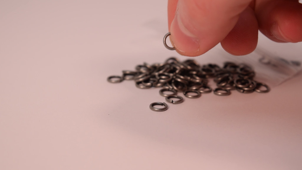 Grab a jump ring and pry it open, slide it onto the top of the pyramid.