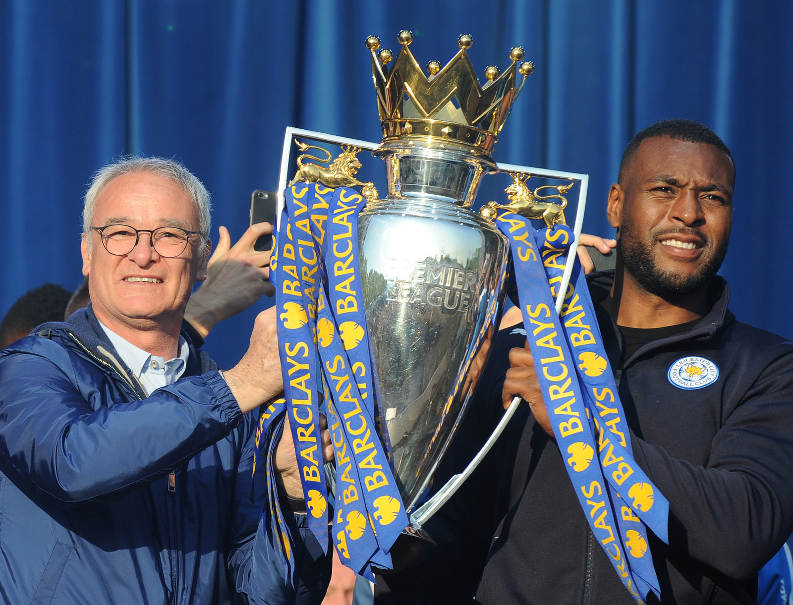Manager Claudio Ranieri and captain Wes Morgan hold up the Premier League trophy in Victoria Park.