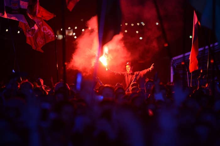 Festivalgoers listen to Florence Welch perform on the Pyramid Stage at Glastonbury in 2015.